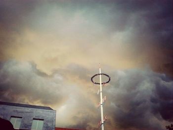 Low angle view of street light against cloudy sky