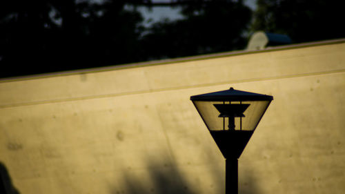 Low angle view of street light against building