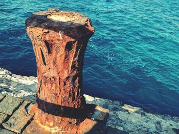 Close-up of wood against sea