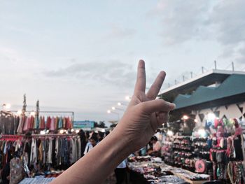 Close-up of hand showing peace sign at street market