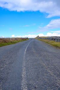 Empty road along countryside landscape