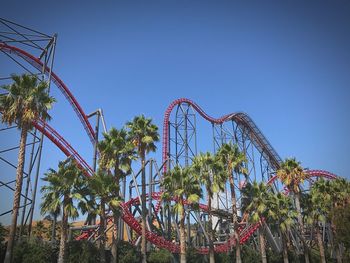 Low angle view of rollercoaster against clear sky