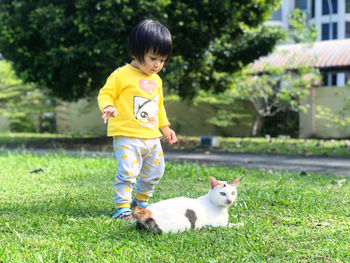 Full length of a girl standing on grass