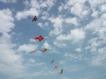 Low angle view of kites against sky