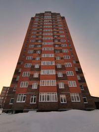 Low angle view of building against sky during winter