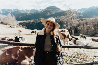 Portrait of young woman standing on field