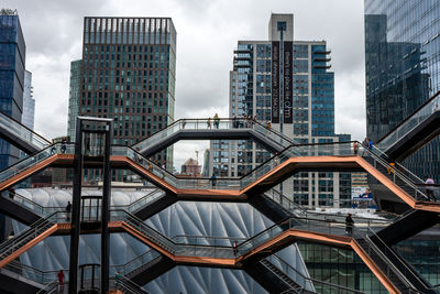 Low angle view of modern buildings in city against sky