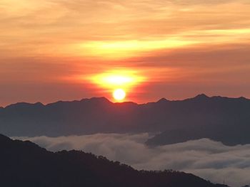 Scenic view of silhouette mountains against sky during sunset