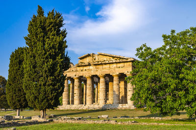 Low angle view of historical building against clear blue sky  , temple of paestum. italy