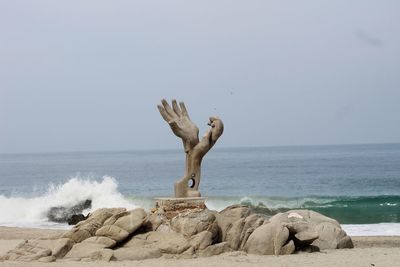 Statue of sea against clear sky