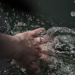 Cropped hand in river