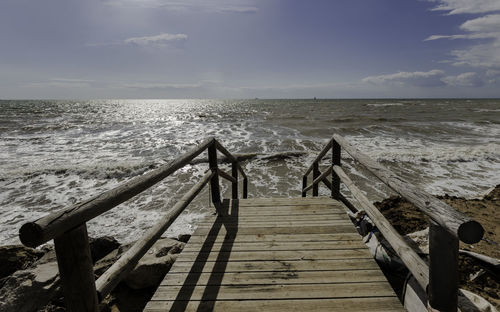 Pier over sea against sky