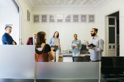 Male and female entrepreneurs discussing strategies at workplace