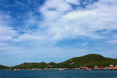 Scenic view of sea and mountains against sky