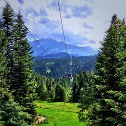 Scenic view of mountains against cloudy sky