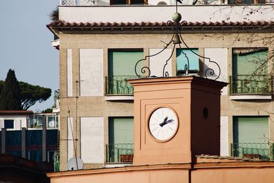 Low angle view of clock tower against building