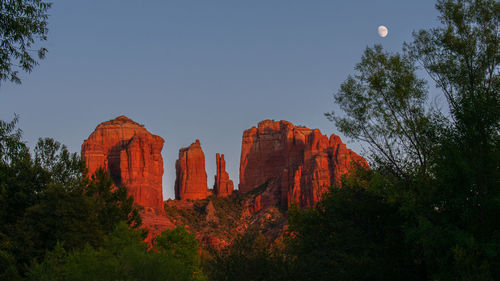 Low angle view of rock formations against sky