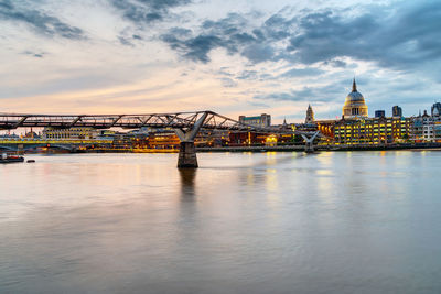 The millennium bridge and st. paul's cathedral in london, uk, just after sunset