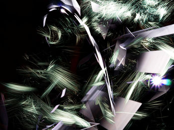 Close-up of illuminated lighting equipment against black background