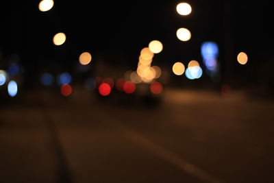 Defocused image of illuminated street lights at night