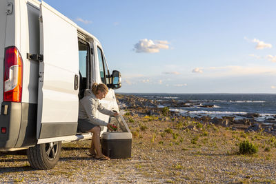 Woman in van at sea