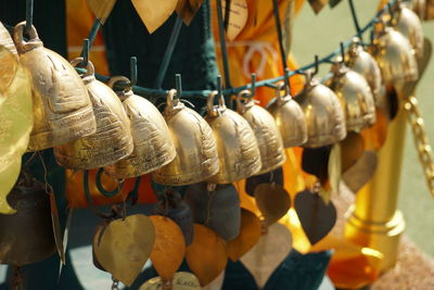 Close-up of bells hanging for sale in market