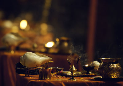 Close-up of religious equipment on table at home during diwali