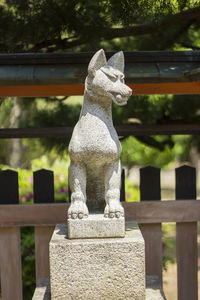 Close-up of statue against railing