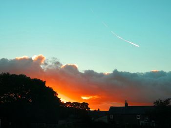 Low angle view of silhouette buildings against sky during sunset