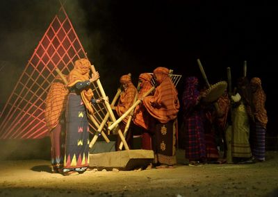 Sculpture in traditional clothing at night