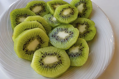 Close up sliced kiwi fruits on white plate