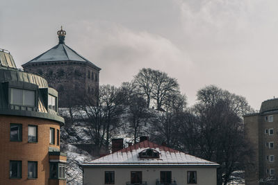 View of houses and buildings against sky