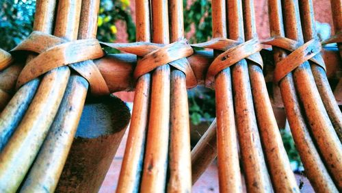 Full frame shot of bamboo tied up on metal fence