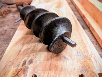 High angle view of equipment and wooden planks on table