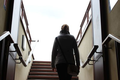 Low angle view of man standing on stairs