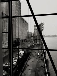 Cars on bridge in city against sky