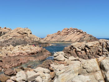 Rocks on cliff against clear sky