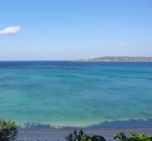 Scenic view of sea against blue sky