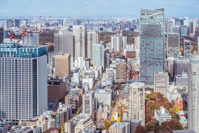 High angle view of modern buildings in city against sky