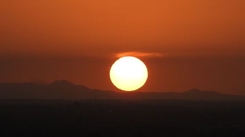 Scenic view of silhouette mountains against sky during sunset