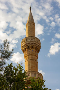 Building tower with tree leaves