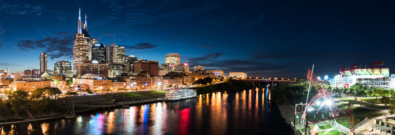 Illuminated city at waterfront