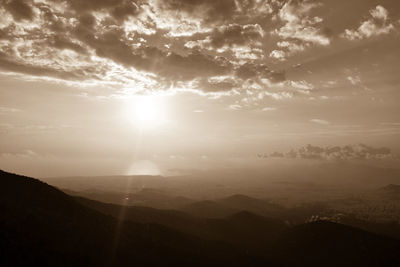 Scenic view of silhouette mountains against sky during sunset