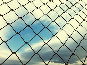 Full frame shot of chainlink fence against sky