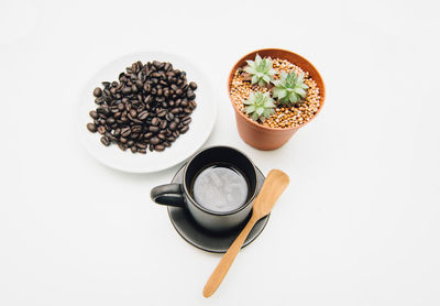 High angle view of coffee on table against white background