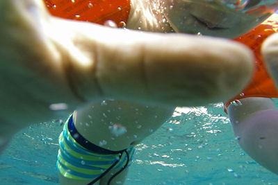 Cropped image of boy swimming in sea