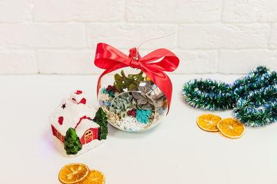 Close-up of christmas decoration on table against wall