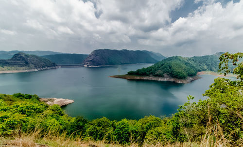 Scenic view of sea and trees against sky