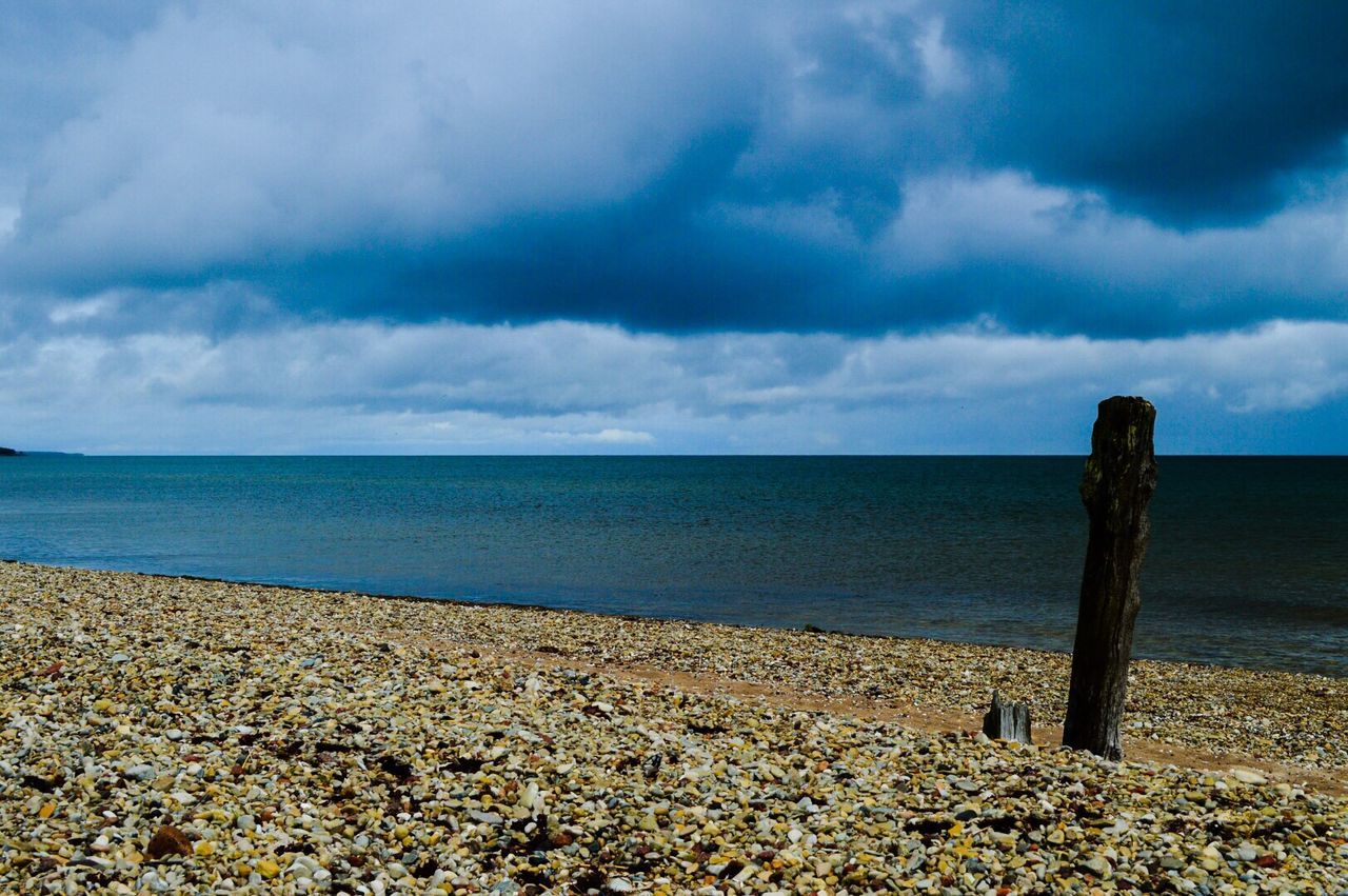 sea, horizon over water, sky, water, tranquil scene, beach, tranquility, scenics, beauty in nature, cloud - sky, shore, nature, cloudy, cloud, idyllic, calm, rock - object, blue, remote, seascape