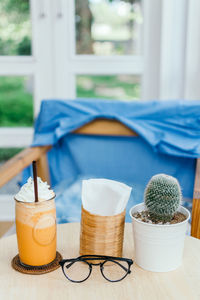 Close-up of drink and cactus on table